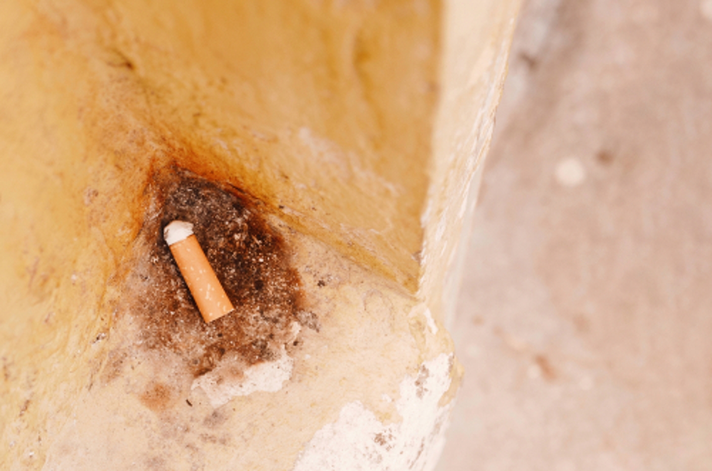 cigarette with yellow wall shutterstock 1501655819